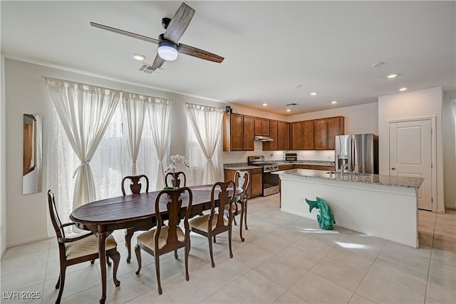 tiled dining room featuring ceiling fan