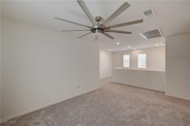 carpeted empty room featuring ceiling fan