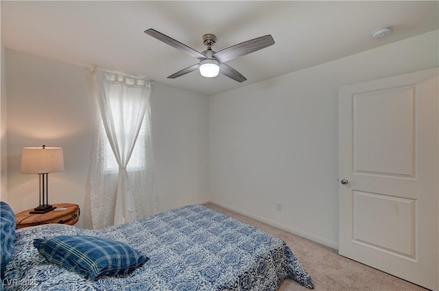 bedroom featuring light carpet and ceiling fan