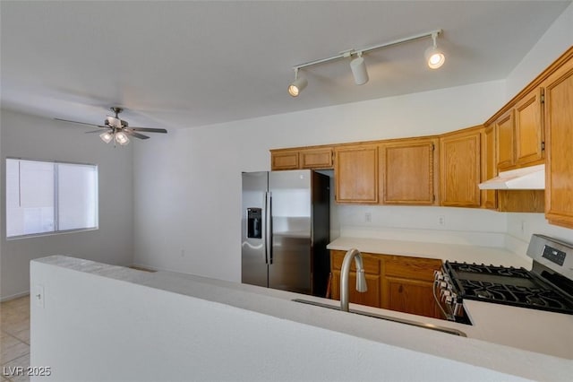 kitchen with ceiling fan, stainless steel appliances, sink, and light tile patterned floors