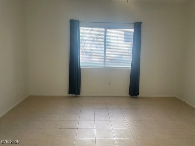 empty room featuring light tile patterned floors