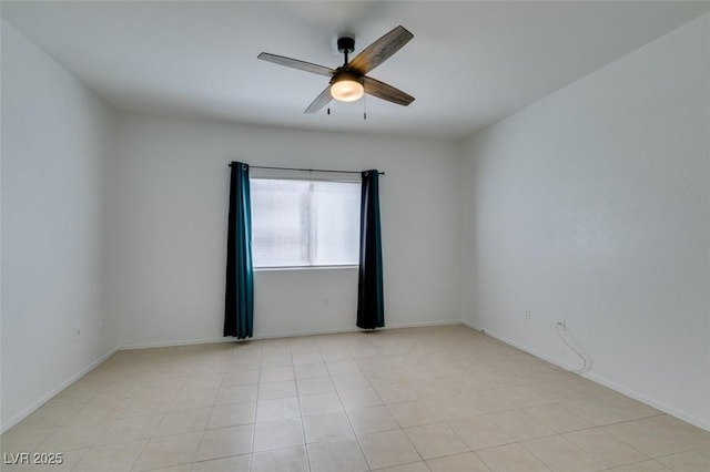 tiled empty room featuring ceiling fan