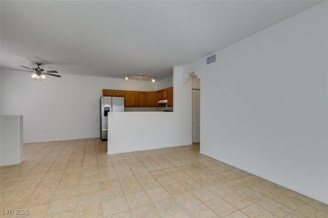 unfurnished living room with ceiling fan