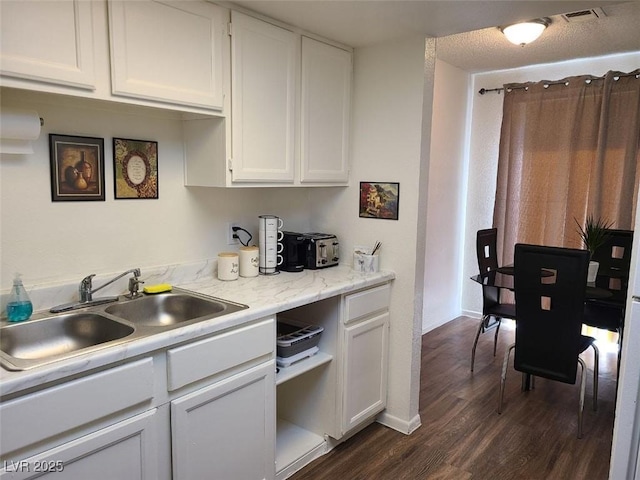 kitchen featuring sink, white cabinets, and dark hardwood / wood-style flooring