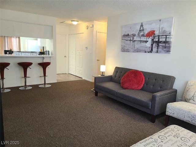 living room featuring carpet and a textured ceiling