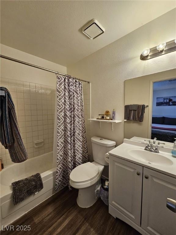 full bathroom with vanity, hardwood / wood-style flooring, toilet, and shower / bath combo with shower curtain