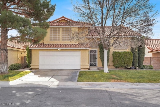 mediterranean / spanish home with a garage and a front lawn