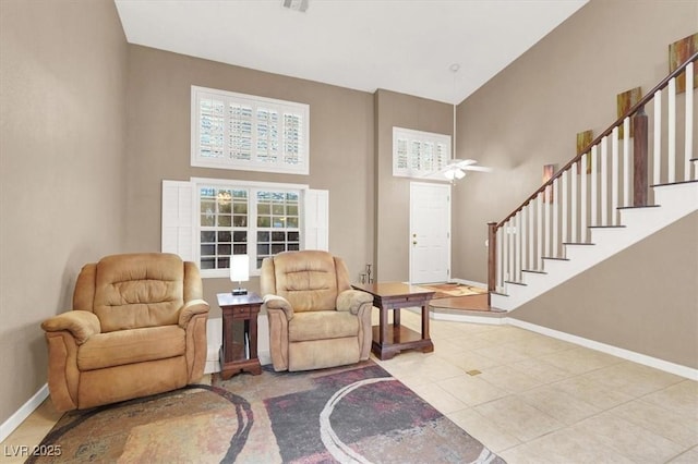 sitting room featuring a towering ceiling and light tile patterned flooring