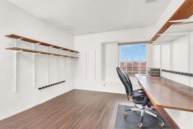 unfurnished office with dark hardwood / wood-style flooring