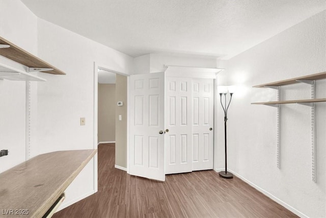 interior space featuring wood-type flooring and a textured ceiling