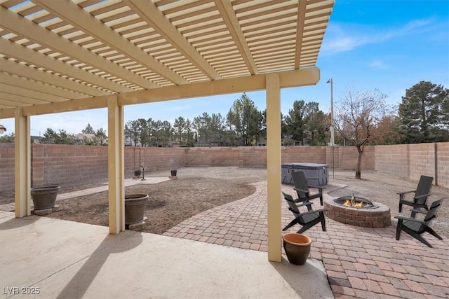 view of patio featuring a hot tub, a pergola, and an outdoor fire pit