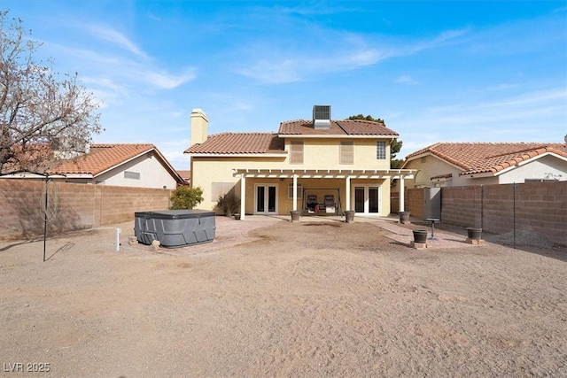 rear view of property featuring central AC, a hot tub, a pergola, and a patio