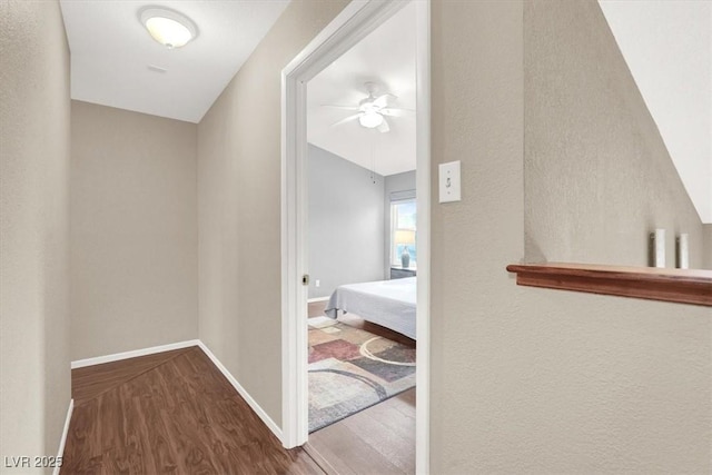 hallway with hardwood / wood-style floors