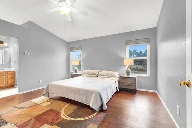 bedroom featuring lofted ceiling, dark hardwood / wood-style flooring, ceiling fan, and ensuite bathroom