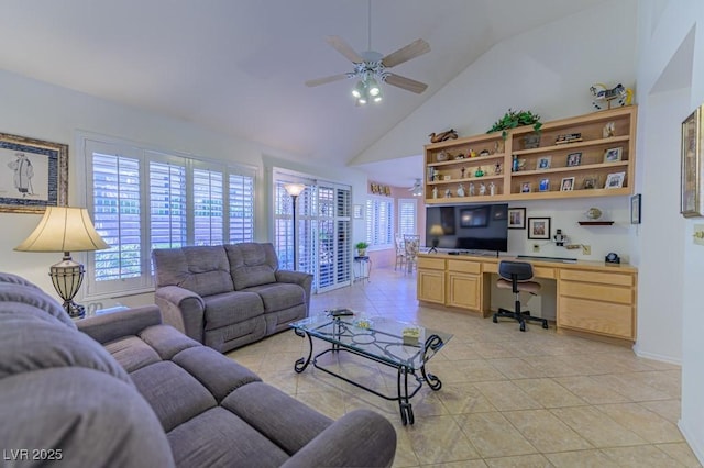 living area with light tile patterned floors, high vaulted ceiling, ceiling fan, baseboards, and built in study area