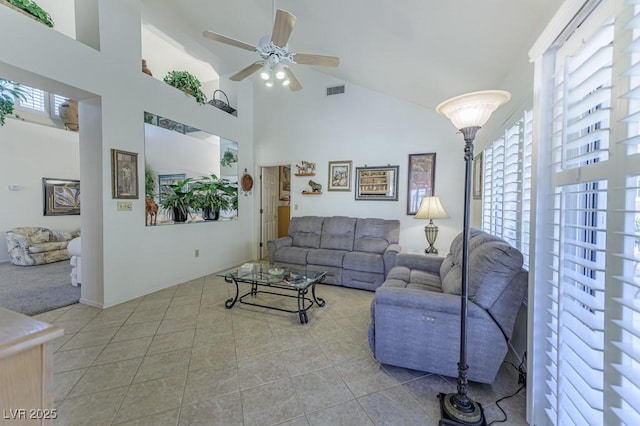 living room featuring a healthy amount of sunlight, high vaulted ceiling, a ceiling fan, and tile patterned floors