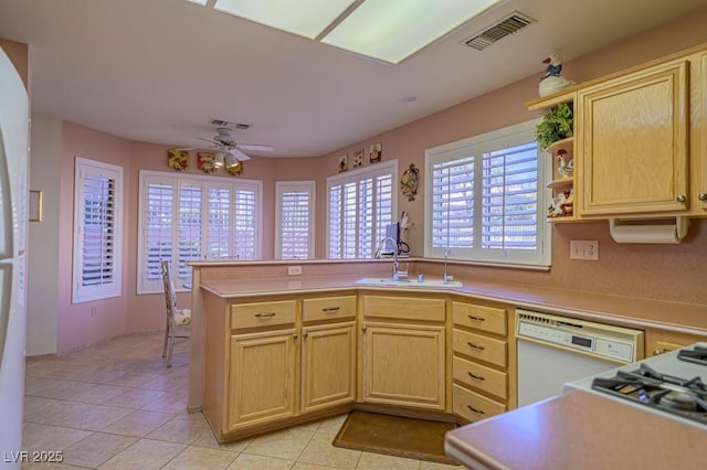 kitchen featuring visible vents, light countertops, dishwasher, and light brown cabinetry