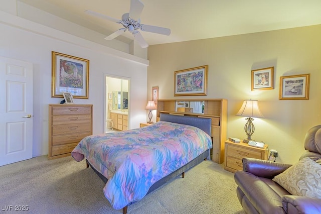 carpeted bedroom with ceiling fan, connected bathroom, and lofted ceiling