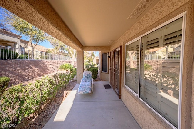 view of patio with visible vents and fence