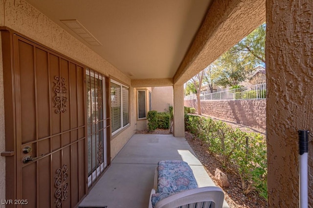 view of patio / terrace featuring fence