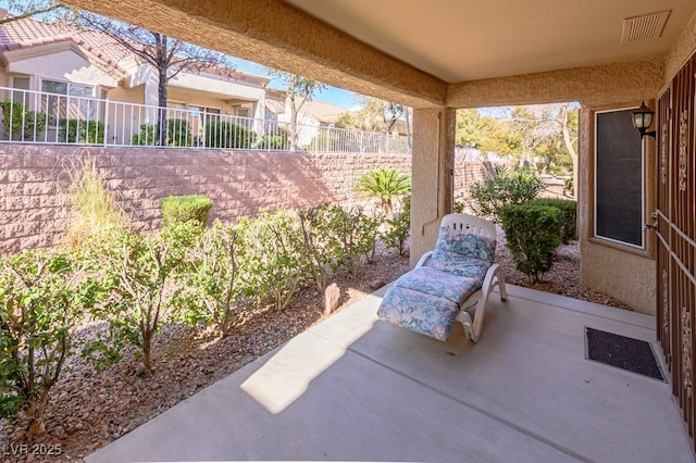 view of patio with fence and visible vents