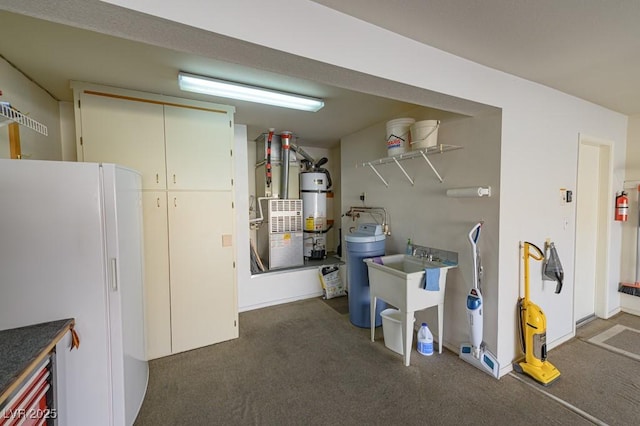 interior space featuring freestanding refrigerator, secured water heater, and heating unit