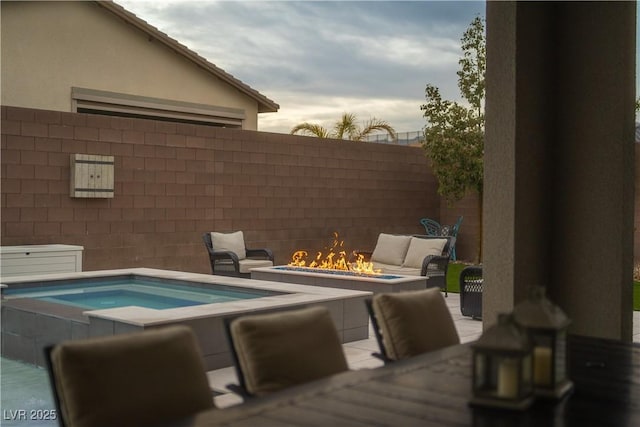 view of swimming pool featuring an in ground hot tub, a patio, and a fire pit