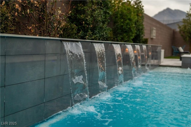 view of pool featuring pool water feature