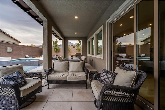 patio terrace at dusk featuring a fenced in pool