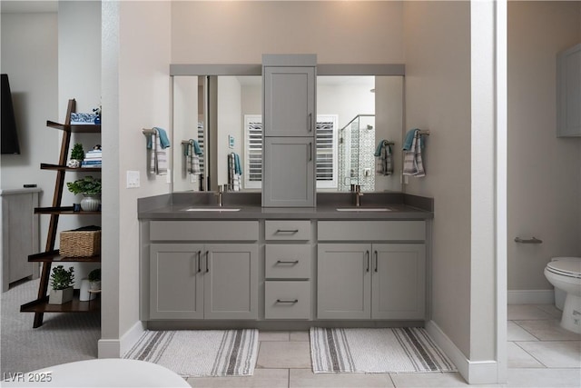 bathroom with an enclosed shower, vanity, tile patterned floors, and toilet