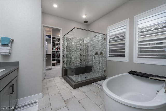 bathroom with tile patterned floors, vanity, and independent shower and bath