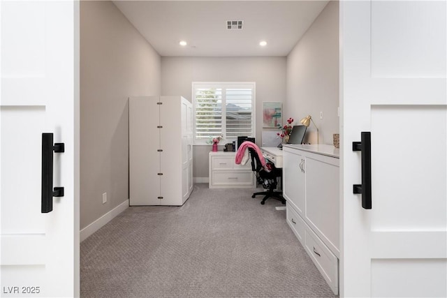 unfurnished office featuring light colored carpet