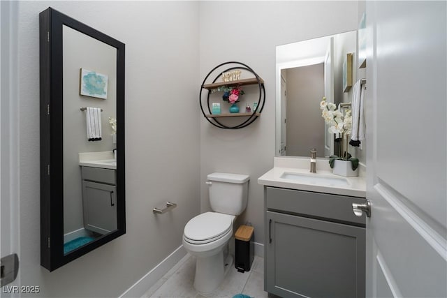 bathroom with tile patterned flooring, vanity, and toilet