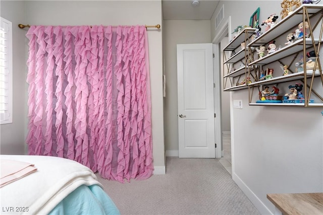 bedroom featuring light colored carpet