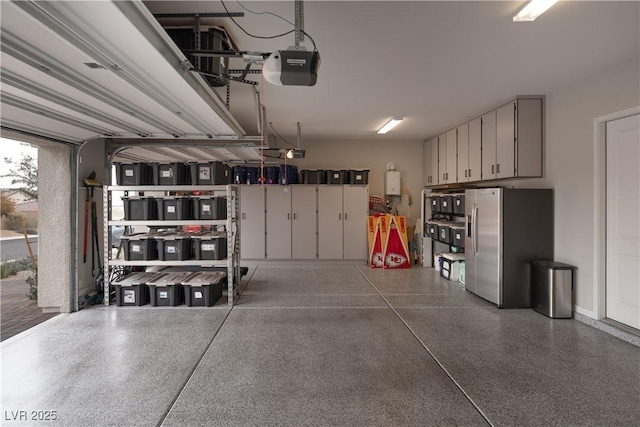 garage with a garage door opener and stainless steel fridge