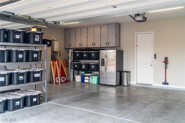 garage with a garage door opener and stainless steel fridge with ice dispenser