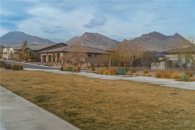 surrounding community featuring a mountain view and a lawn