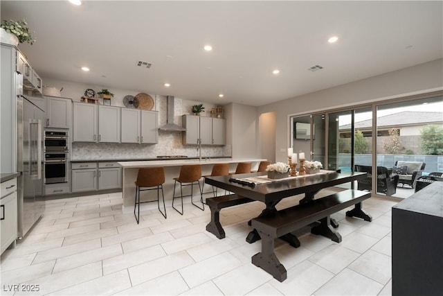 tiled dining room featuring sink