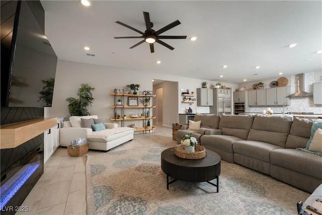 living room with sink and ceiling fan