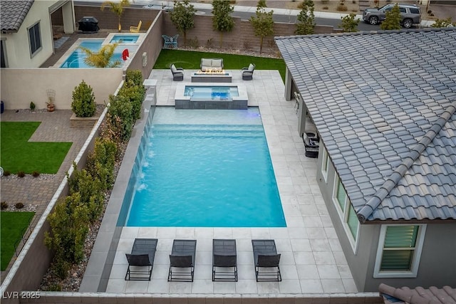 view of swimming pool with an in ground hot tub, pool water feature, and a patio