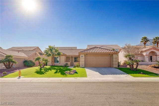 mediterranean / spanish-style house featuring a garage and a front lawn