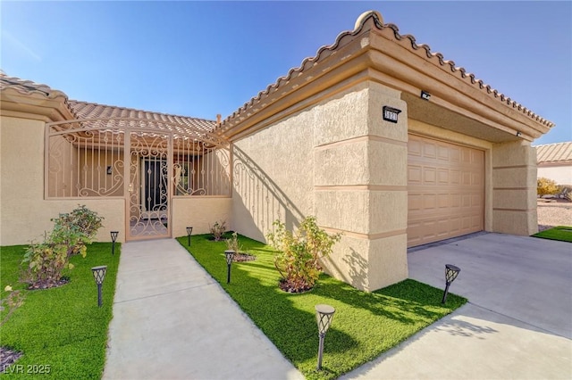 view of front of home with a garage and a front lawn