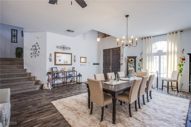 dining room featuring hardwood / wood-style floors and ceiling fan with notable chandelier