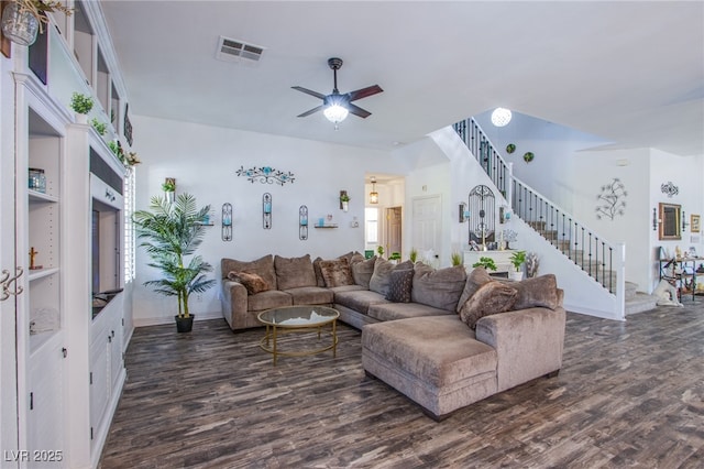 living room with dark hardwood / wood-style flooring and ceiling fan