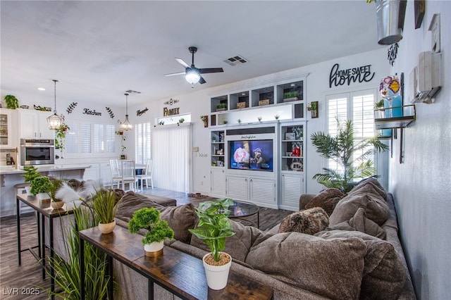 living room with hardwood / wood-style floors and ceiling fan