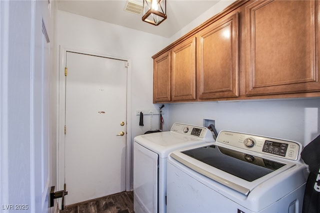 clothes washing area with cabinets, separate washer and dryer, and dark hardwood / wood-style floors