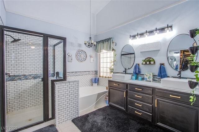 bathroom with shower with separate bathtub, vaulted ceiling, a chandelier, tile patterned flooring, and vanity