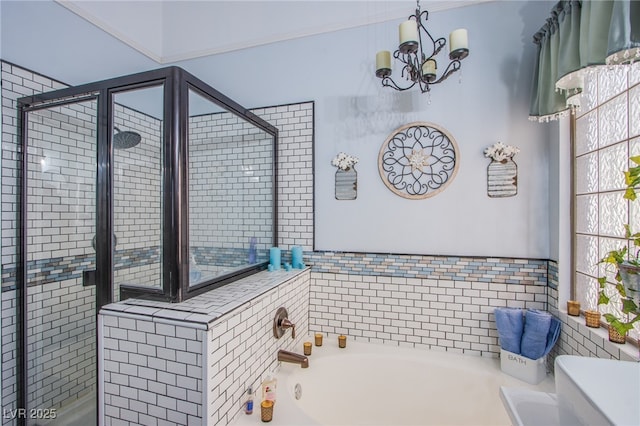 bathroom featuring shower with separate bathtub and an inviting chandelier