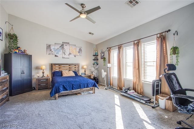 carpeted bedroom with ceiling fan and vaulted ceiling