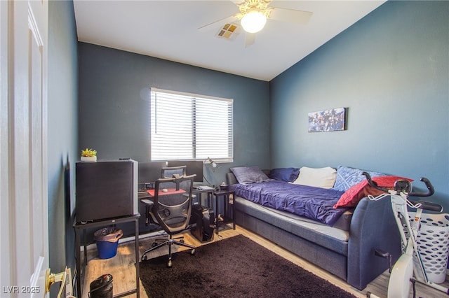 bedroom with vaulted ceiling, hardwood / wood-style floors, and ceiling fan